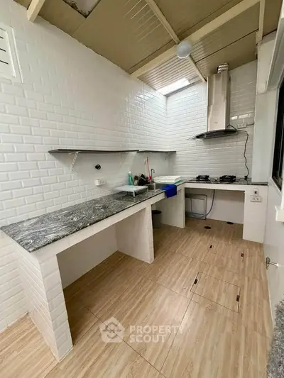 Modern kitchen with gas stove and sleek countertops in a bright, open layout.