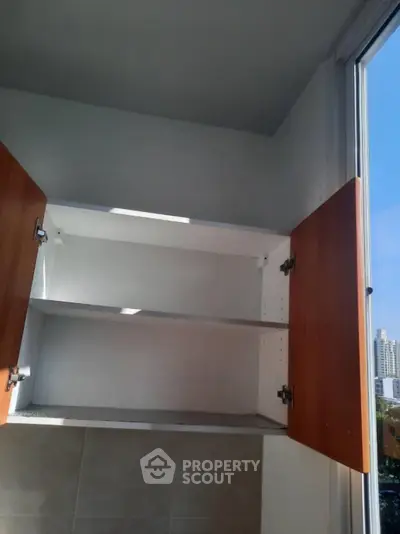 Spacious kitchen cabinet with open doors and natural light