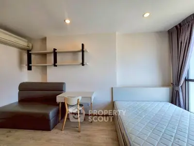 Modern studio apartment with minimalist furniture and natural light