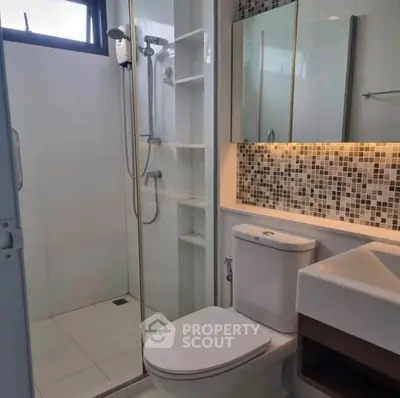 Modern bathroom with glass shower and stylish tile backsplash