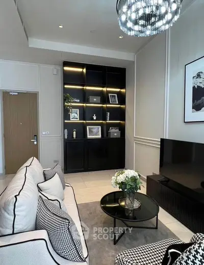 Elegant living room with modern decor, plush seating, and stylish shelving unit.