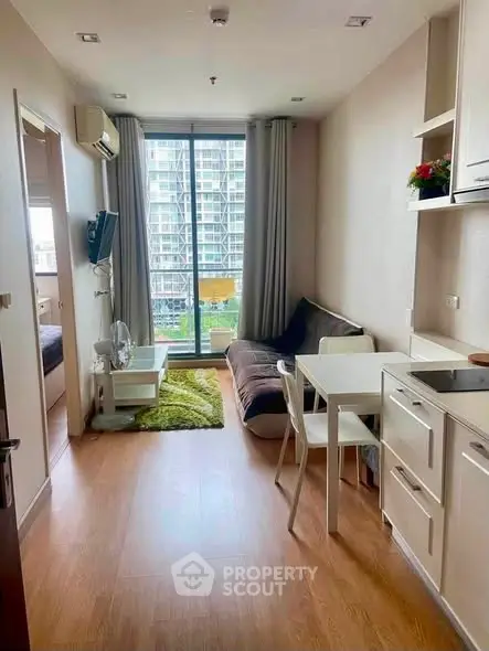 Modern studio apartment with open layout and large window view