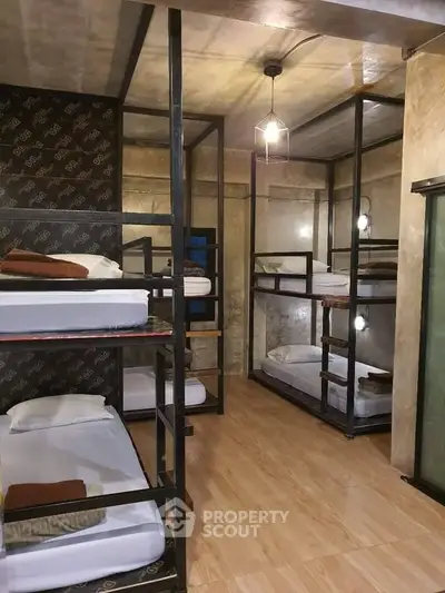 Modern dormitory room with multiple bunk beds and stylish lighting