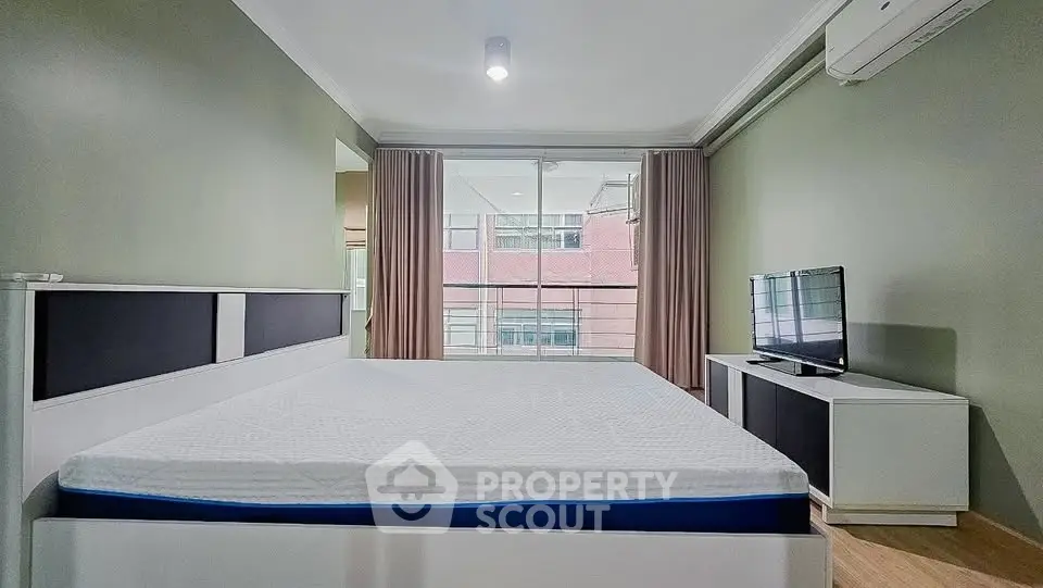 Spacious modern bedroom with large window and minimalist decor