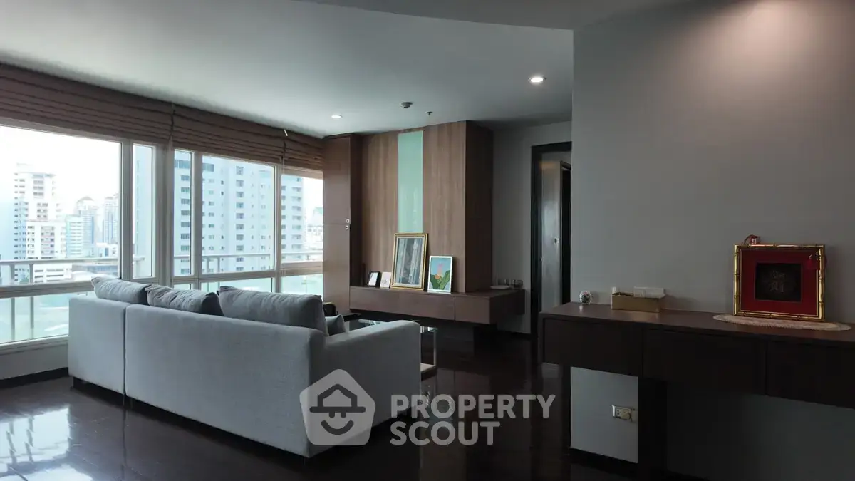Spacious modern living room with large windows and city view