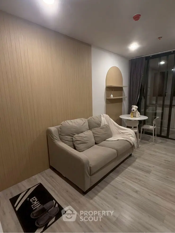 Cozy living room with modern decor and balcony access