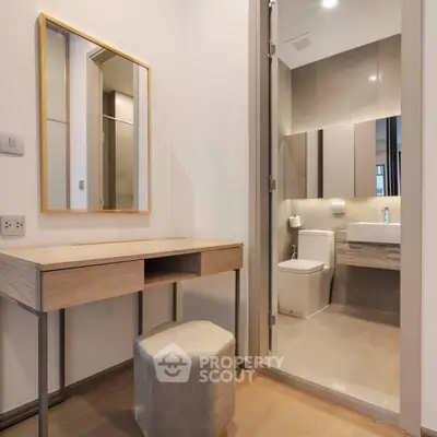 Modern bathroom with elegant vanity and mirror in a stylish apartment.