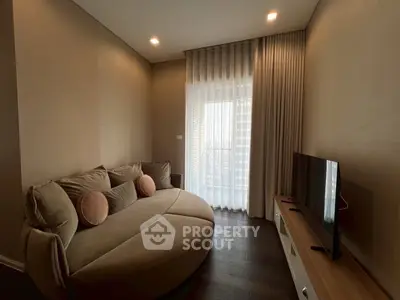 Cozy living room with modern sofa and TV, perfect for relaxation.