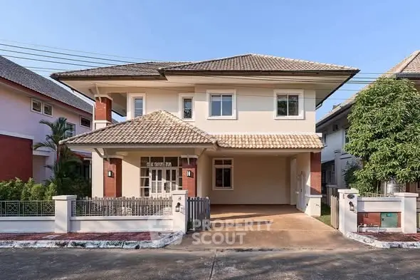 Charming two-story house with tiled roof and spacious driveway in a serene neighborhood.