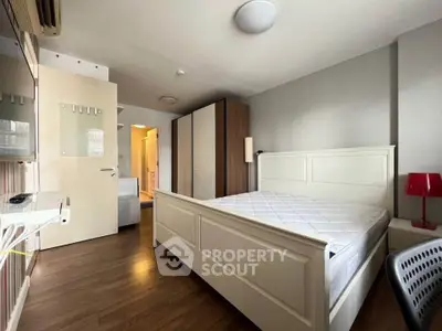 Spacious bedroom with modern furnishings and ample natural light