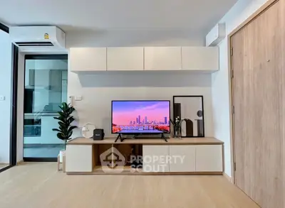 Modern living room with sleek TV stand and wall-mounted cabinets