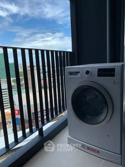 Modern balcony with city view and Bosch washing machine, perfect for urban living.