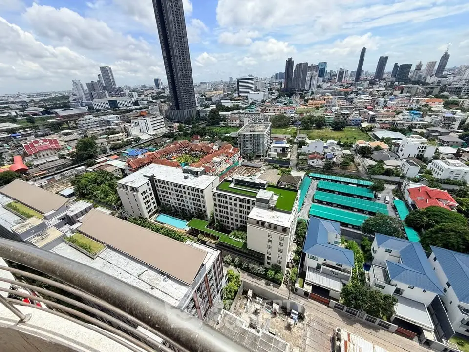 Stunning cityscape view from high-rise balcony showcasing urban skyline and residential buildings.