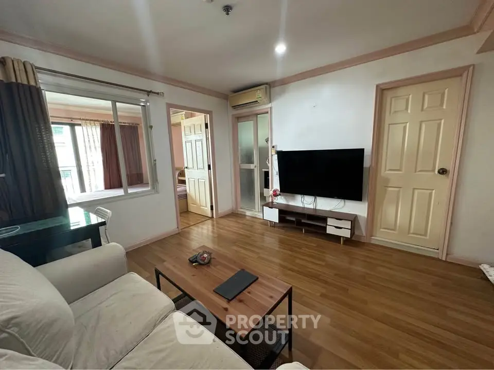 Spacious living room with modern decor and large window for natural light