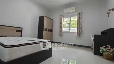 Spacious bedroom with modern furniture and natural light