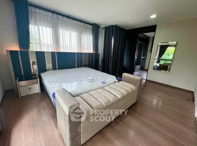 Spacious modern bedroom with large windows and elegant decor
