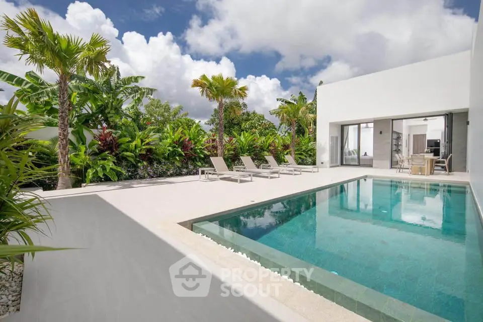 Luxurious modern villa with private pool and lush tropical garden, perfect for serene living.