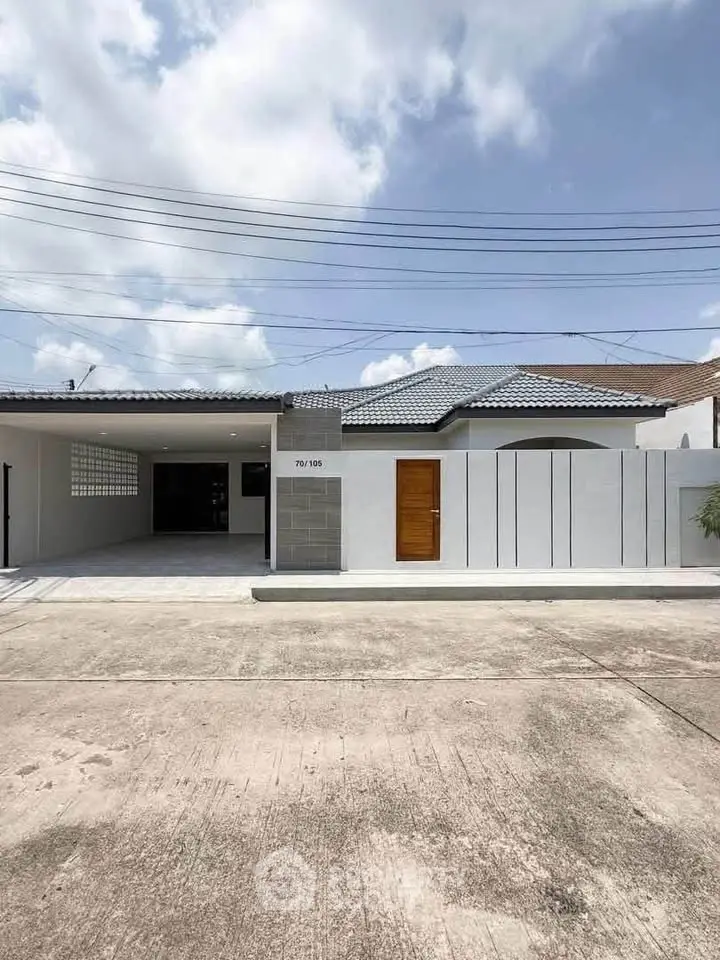 Modern single-story house with sleek design and spacious driveway in a serene neighborhood.
