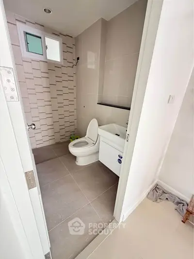 Modern bathroom with sleek tiles and contemporary fixtures in a stylish apartment.