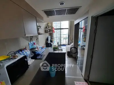 Modern kitchen with open layout and city view, featuring sleek cabinetry and appliances.