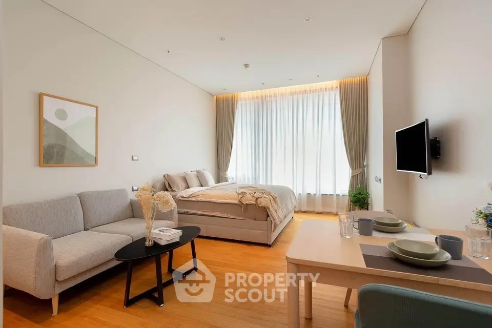 Modern studio apartment with cozy living area and stylish decor