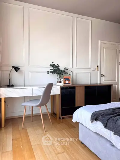 Elegant bedroom with stylish desk and chair, featuring modern decor and cozy ambiance.