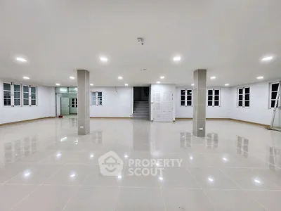 Spacious open-plan interior with tiled flooring and ample natural light, perfect for versatile use.