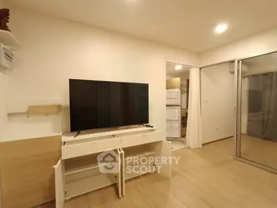 Modern living room with sleek TV setup and open storage cabinets
