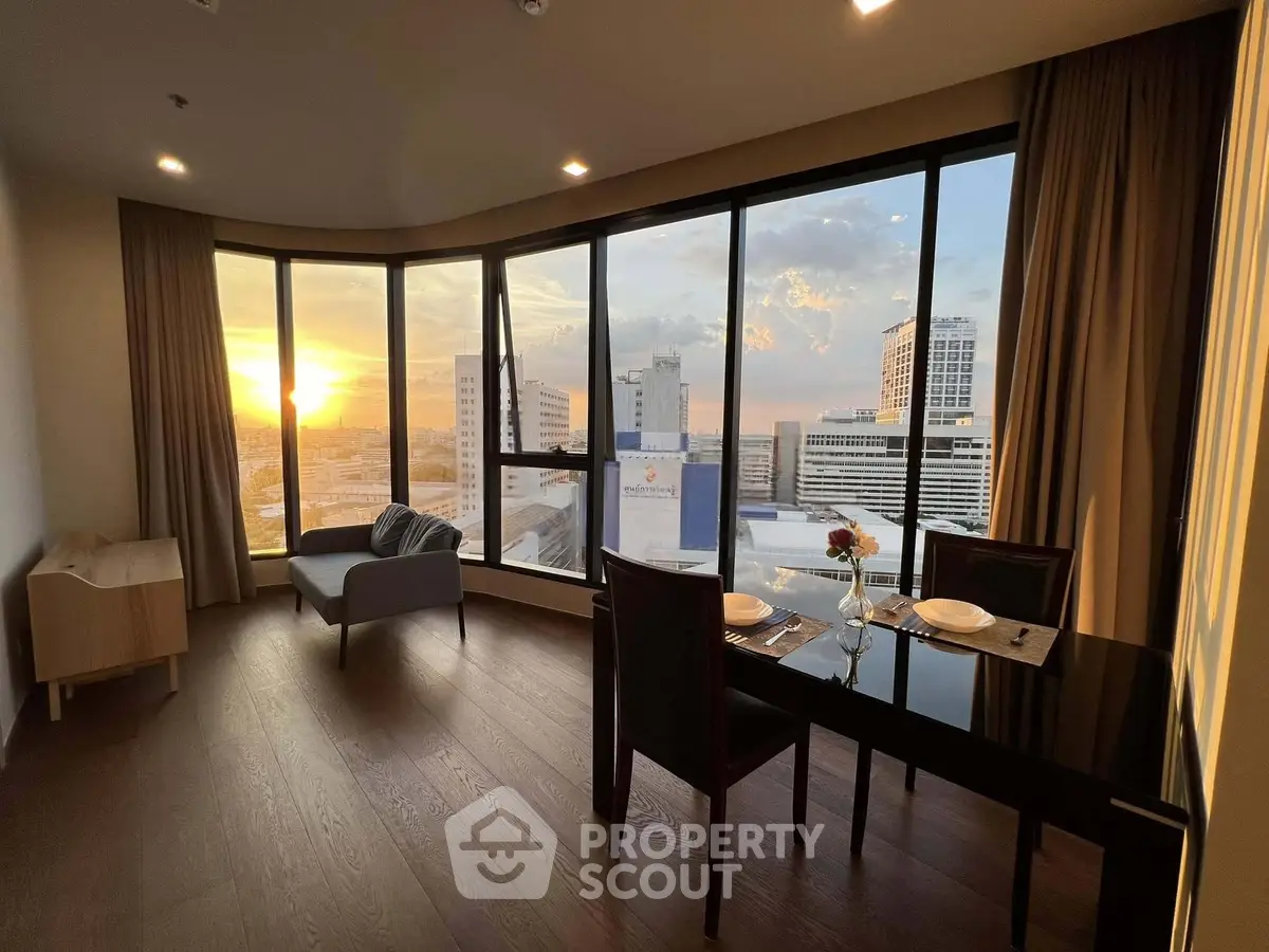Stunning high-rise apartment with panoramic city views and elegant dining area at sunset.