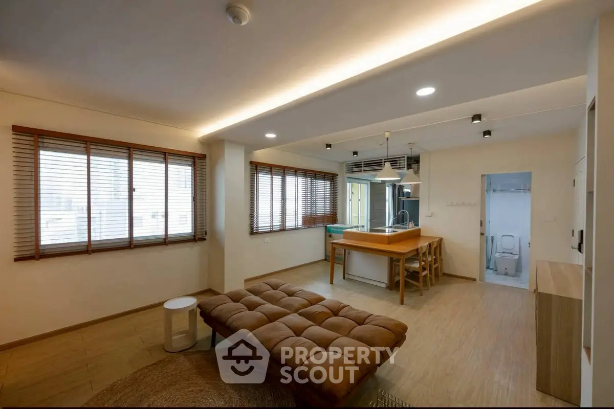 Spacious living room with modern open kitchen and natural light