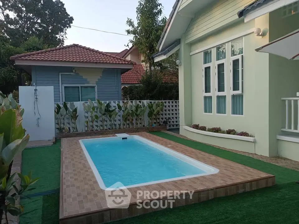 Charming backyard with a small pool and lush greenery, perfect for relaxation and outdoor enjoyment.