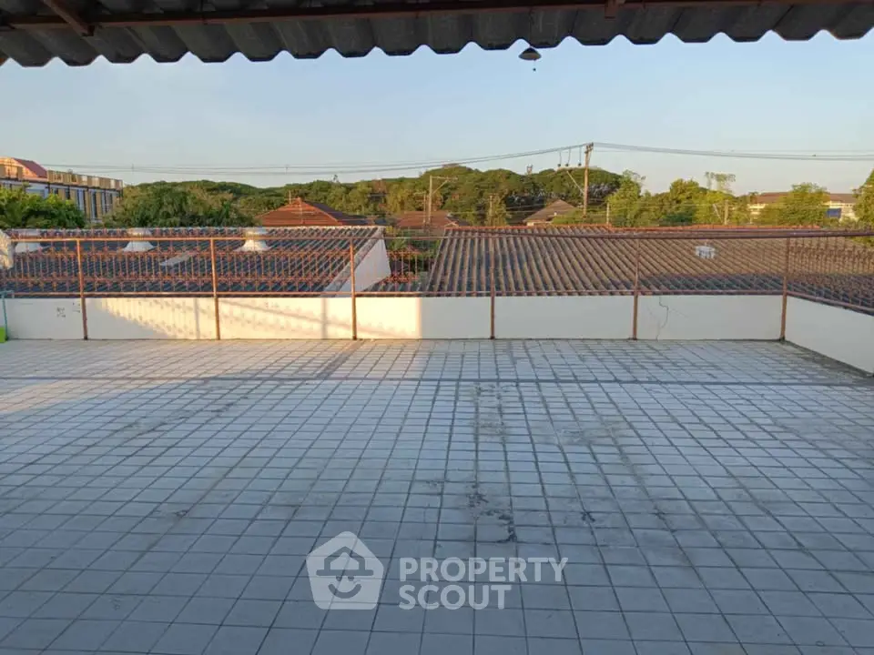 Spacious rooftop terrace with tiled flooring and scenic neighborhood view.