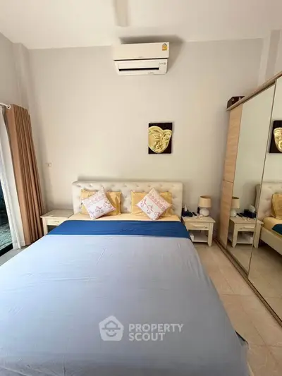 Cozy bedroom with modern decor and mirrored wardrobe