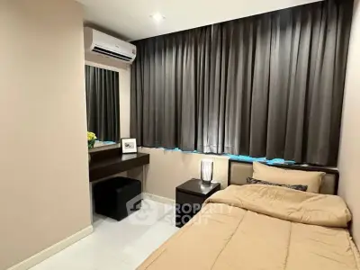 Cozy bedroom with single bed, modern decor, and air conditioning.