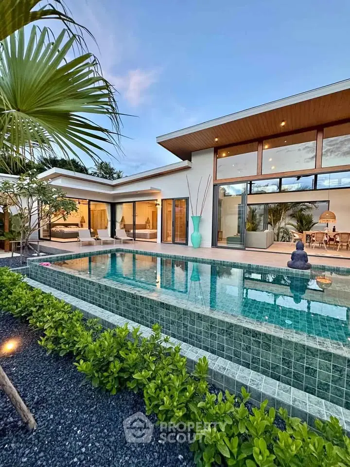Luxurious modern villa with stunning pool and lush greenery, perfect for serene living.