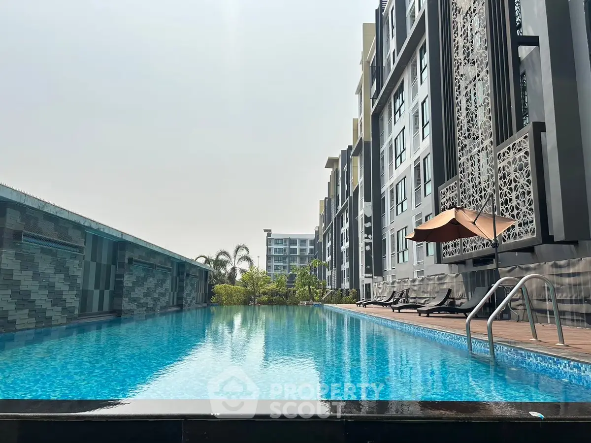 Luxurious apartment complex with stunning outdoor pool and modern design.