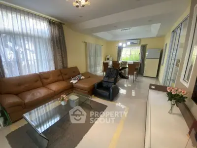 Spacious living room with modern furniture and open dining area