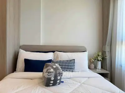 Cozy bedroom with stylish decor and natural light, perfect for relaxation and comfort.