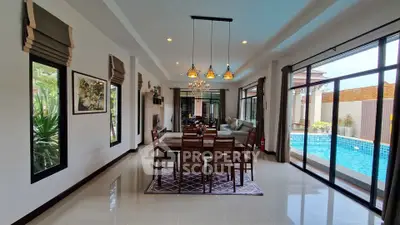 Luxurious dining area with pool view in modern home
