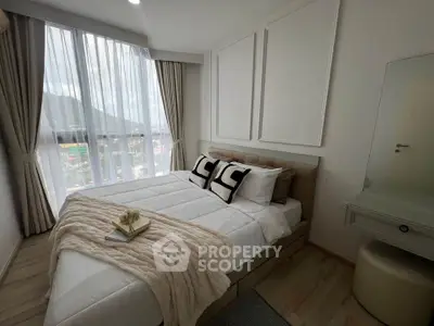 Modern bedroom with large window and stylish decor