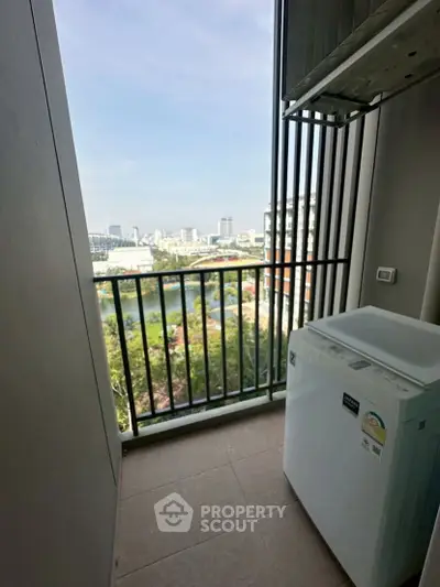Charming balcony with city view and washing machine, perfect for urban living convenience.