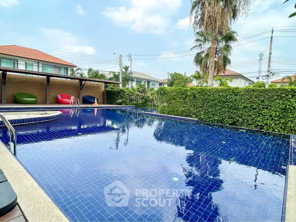Luxurious outdoor pool area with lush greenery and modern design, perfect for relaxation and leisure.