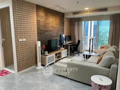 Modern living room with city view, stylish decor, and cozy seating area in a high-rise apartment.