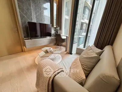 Modern living room with large TV and floor-to-ceiling windows in luxury apartment