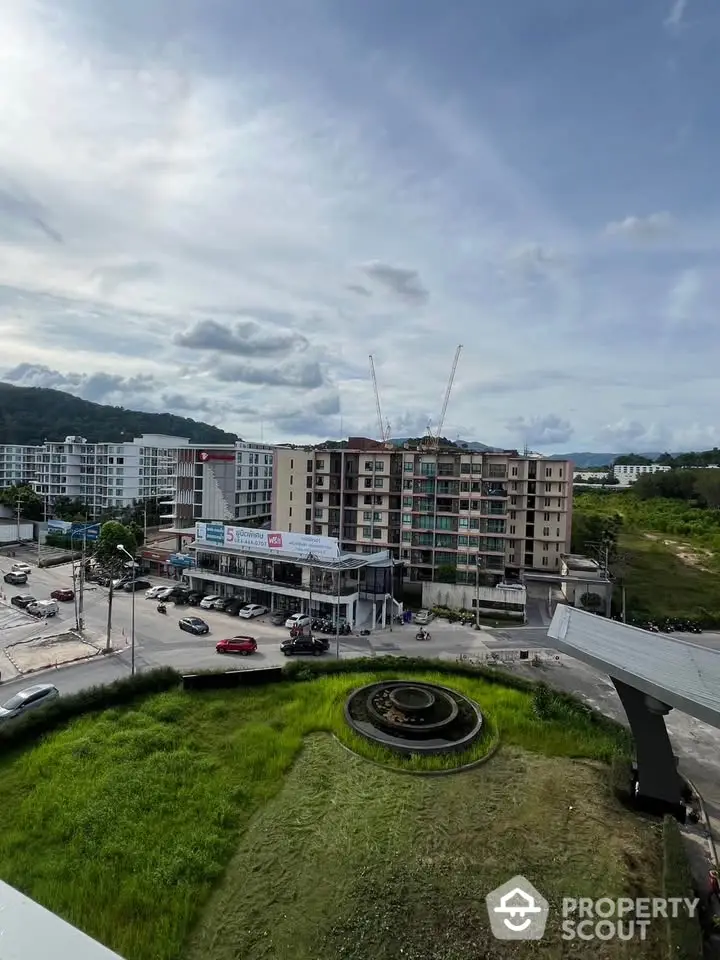 Panoramic view of urban residential buildings with lush green surroundings and clear sky.