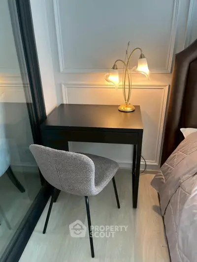 Stylish bedroom corner with elegant desk and modern lamp