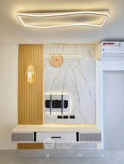 Modern living room with stylish wall paneling and sleek lighting design