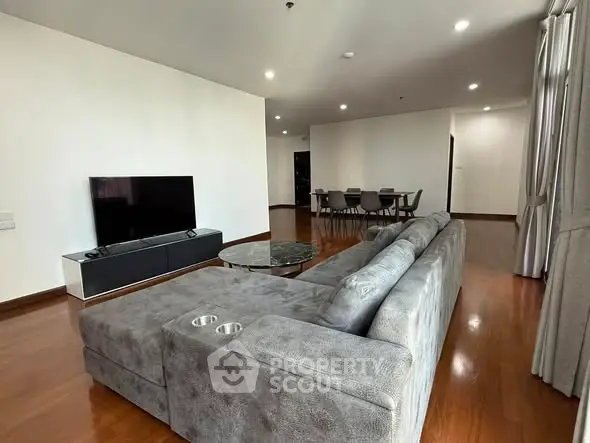 Spacious modern living room with sleek furniture and hardwood floors