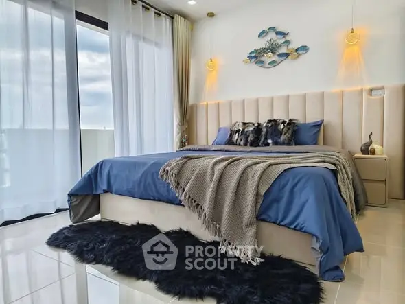 Luxurious bedroom with plush decor and floor-to-ceiling windows offering natural light.