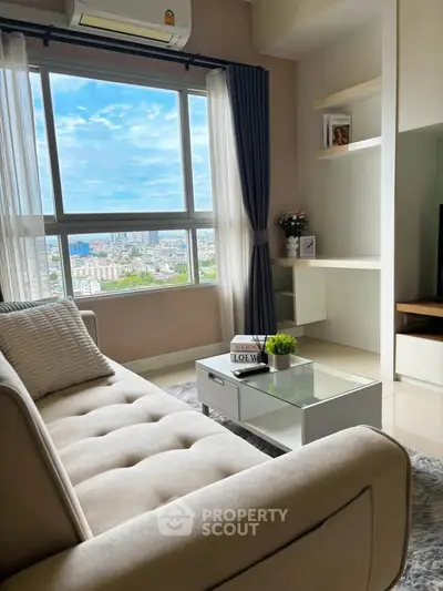 Modern living room with city view, stylish sofa, and elegant decor in high-rise apartment.